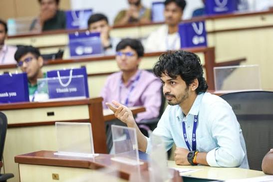 A young participant asking a question during a session
