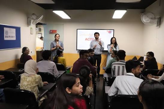 A facilitator running a classroom activity with students
