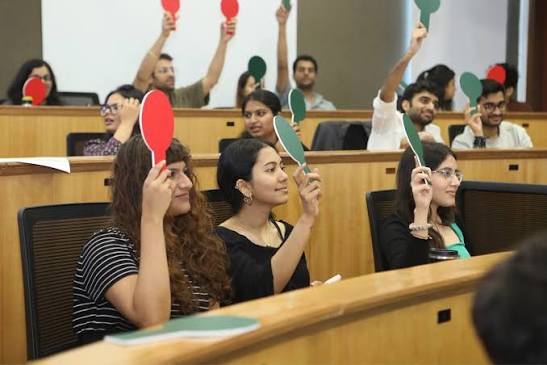Participants raising cards to vote during an interactive session