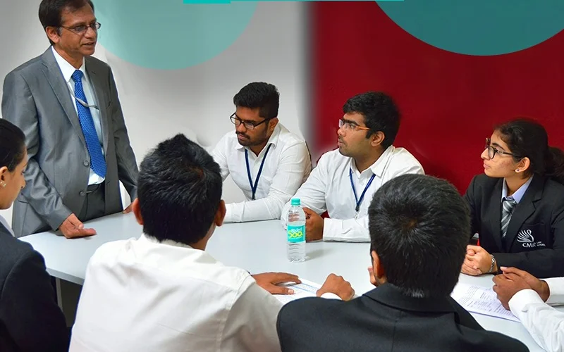 A mentor guiding a roundtable discussion with students