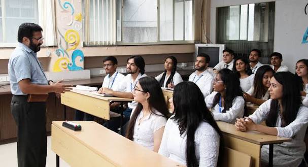 A facilitator guiding a small classroom conversation